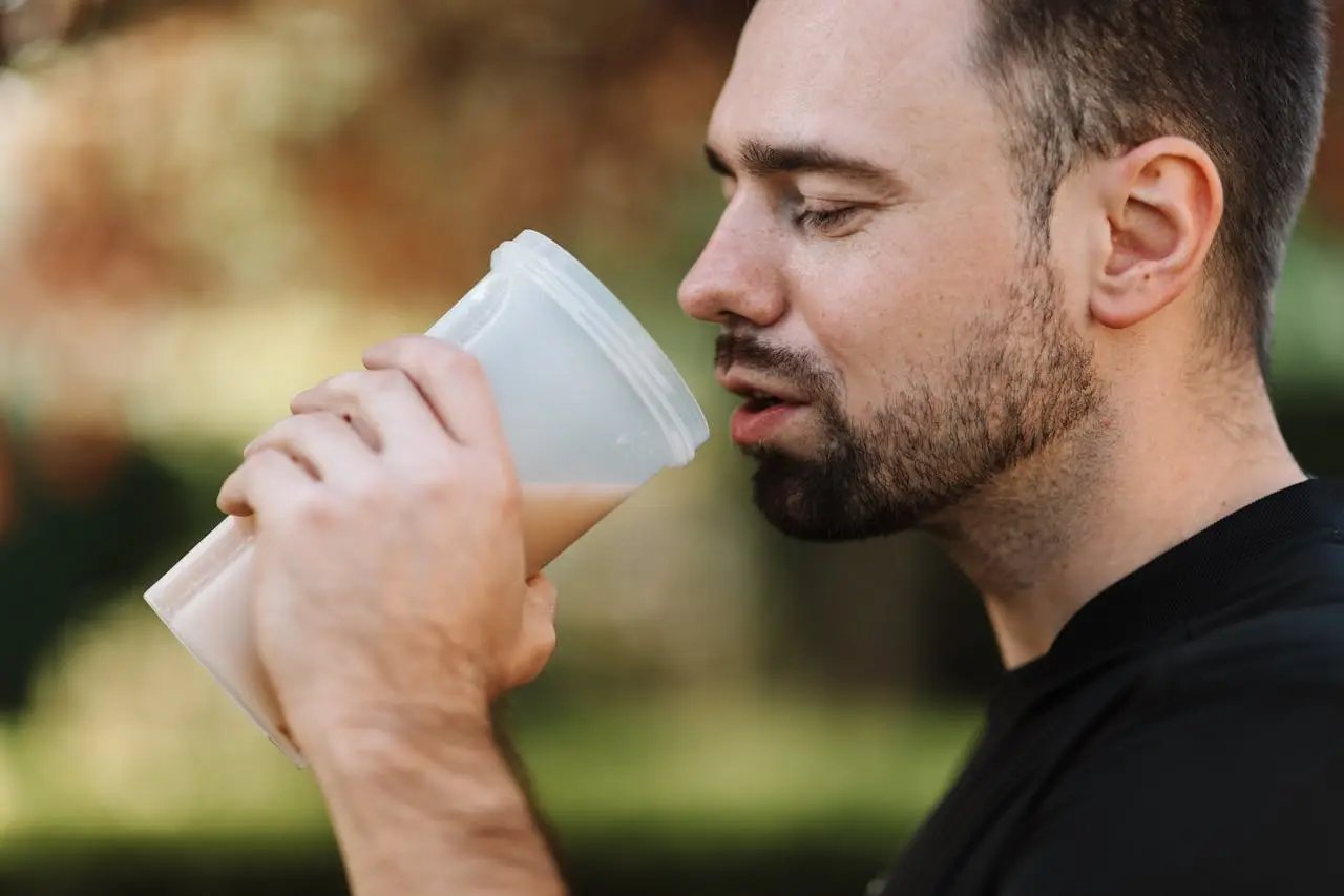 Man drinking protein shake or pre-workout