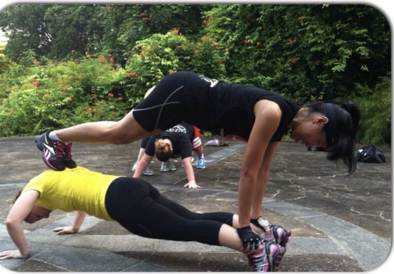 Attempting a plank tower at Fort Canning bootcamp training.